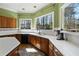 Well-lit kitchen with custom cabinets, white countertops, and windows with views of trees at 3410 Kates Way, Duluth, GA 30097