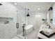 A stylish bathroom features a soaking tub, a glass shower, and modern fixtures at 1168 Mclynn Ne Ave, Atlanta, GA 30306
