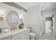 Beautiful bathroom featuring subway tile, a large round mirror, and brass fixtures at 1168 Mclynn Ne Ave, Atlanta, GA 30306