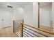 Bright hallway with wood floors, modern railings, and a unique brick accent wall at 1168 Mclynn Ne Ave, Atlanta, GA 30306