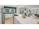 Modern kitchen with stainless steel appliances, large island, and a view into the dining and living rooms at 1168 Mclynn Ne Ave, Atlanta, GA 30306