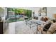 Living room with backyard views from the floor to ceiling sliding glass doors and curated modern furnishings at 1168 Mclynn Ne Ave, Atlanta, GA 30306