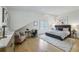 Well lit main bedroom with wood floors, a large bed, sitting area and natural light at 1168 Mclynn Ne Ave, Atlanta, GA 30306