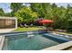 Beautiful pool and spa with a waterfall feature and lush landscaping at 1168 Mclynn Ne Ave, Atlanta, GA 30306