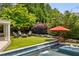 Inviting pool area with waterfall feature, complemented by an outdoor seating area and lush landscaping at 1168 Mclynn Ne Ave, Atlanta, GA 30306