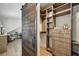 Custom walk-in closet with a wooden barn door, ample shelving, drawers, and storage space at 1168 Mclynn Ne Ave, Atlanta, GA 30306