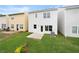 A home's backyard, complete with lawn, HVAC, and a small patio at 150 Chandler Trce, Covington, GA 30016