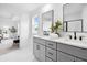 Primary bath with double vanity, quartz countertop, framed mirrors, modern faucets and ceramic flooring at 150 Chandler Trce, Covington, GA 30016