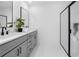Modern bathroom with double sinks, sleek vanity, and a glass-enclosed shower at 150 Chandler Trce, Covington, GA 30016