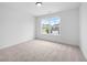 Bright and airy bedroom with a window showing a view of the neighborhood at 150 Chandler Trce, Covington, GA 30016