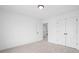 Carpeted bedroom featuring a closet and door leading to the hallway at 150 Chandler Trce, Covington, GA 30016