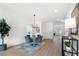 Bright dining room with modern chandelier, wood floors, round table, and stylish decor at 150 Chandler Trce, Covington, GA 30016