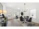Airy dining area with modern lighting, wood floors, and ample natural light from multiple windows at 150 Chandler Trce, Covington, GA 30016
