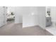 Light-filled hallway featuring neutral carpet, leading to a bathroom and bedroom at 150 Chandler Trce, Covington, GA 30016