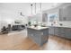 Stylish kitchen featuring stainless steel appliances, a kitchen island, and adjacent to the living area at 150 Chandler Trce, Covington, GA 30016