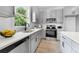 Modern kitchen featuring stainless steel appliances, sleek countertops, and ample cabinet space at 150 Chandler Trce, Covington, GA 30016