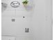 Functional laundry room with floating shelf, white walls and ceramic flooring at 150 Chandler Trce, Covington, GA 30016