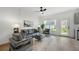 Cozy living room with comfortable seating, ceiling fan, and natural light filtering in at 150 Chandler Trce, Covington, GA 30016