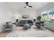 Bright and spacious living room with modern furniture, a ceiling fan, and a serene atmosphere at 150 Chandler Trce, Covington, GA 30016