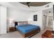 Modern bedroom with soft carpet, a ceiling fan, and a platform bed facing a bathroom entrance at 3324 Peachtree Ne Rd # 1813, Atlanta, GA 30305