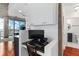 Hallway with built in desk and a view to the modern bathroom and open living area at 3324 Peachtree Ne Rd # 1813, Atlanta, GA 30305