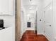 Hallway leading to a bathroom featuring a sleek vanity, toilet, and pristine white doors accentuating modern living at 3324 Peachtree Ne Rd # 1813, Atlanta, GA 30305