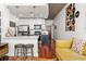 Modern living room with a view into the kitchen that has stainless steel appliances and a breakfast bar at 3324 Peachtree Ne Rd # 1813, Atlanta, GA 30305