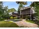 A home's backyard includes a patio, pool, screened porch and mature landscaping at 851 Courtenay Ne Dr, Atlanta, GA 30306