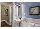 Powder room featuring a pedestal sink, wainscoting detail, and a decorative framed mirror at 851 Courtenay Ne Dr, Atlanta, GA 30306