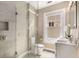 Bright bathroom featuring a glass shower, dual vanity, and a window bringing in natural light at 851 Courtenay Ne Dr, Atlanta, GA 30306