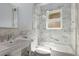 Bathroom showcasing a shower-tub combination, marble tiles, and vintage fixtures at 851 Courtenay Ne Dr, Atlanta, GA 30306
