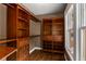 Spacious closet with built-in wood shelving, drawers, and hardwood floors at 851 Courtenay Ne Dr, Atlanta, GA 30306