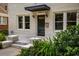 Detailed view of the front entrance, highlighting the stylish door, brickwork, and lush landscaping at 851 Courtenay Ne Dr, Atlanta, GA 30306