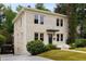 Beautiful two-story home with a brick exterior, lush greenery, and a driveway leading to the side entrance at 851 Courtenay Ne Dr, Atlanta, GA 30306