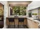 A sunlit kitchen with stainless appliances, a breakfast bar, and a large window with a private, verdant view at 851 Courtenay Ne Dr, Atlanta, GA 30306