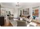 Comfortable living room with hardwood floors, stylish decor, and seamless flow to dining area at 851 Courtenay Ne Dr, Atlanta, GA 30306