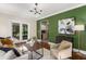 Cozy living room with hardwood floors, chic furnishings, and a bright green accent wall at 851 Courtenay Ne Dr, Atlanta, GA 30306