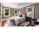 Serene bedroom with hardwood floors, neutral paint, a tufted headboard, and an abundance of natural light at 851 Courtenay Ne Dr, Atlanta, GA 30306