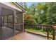 Charming screened-in porch with brown railing overlooking a garden, pool and yard at 851 Courtenay Ne Dr, Atlanta, GA 30306