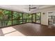 Beautiful screened porch with hardwood floors, a ceiling fan, and views of mature trees at 851 Courtenay Ne Dr, Atlanta, GA 30306
