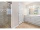 Bathroom with double sinks, a glass-enclosed shower, and tile floors at 1576 Thornwick Trce, Stockbridge, GA 30281