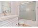 Bathroom featuring a vanity with a light countertop and a tub-shower combo with sliding glass doors at 1576 Thornwick Trce, Stockbridge, GA 30281