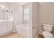 Bright bathroom features a tub, toilet, vanity, and tile flooring at 1576 Thornwick Trce, Stockbridge, GA 30281