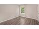 Cozy bedroom with hardwood-look floors, natural light, and neutral paint at 1576 Thornwick Trce, Stockbridge, GA 30281