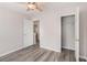 Bedroom with wood-look floors, an open closet, and a door to the hallway at 1576 Thornwick Trce, Stockbridge, GA 30281