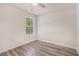 Bright bedroom featuring wood-look floors, a ceiling fan, and a window offering natural light at 1576 Thornwick Trce, Stockbridge, GA 30281