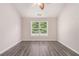 Bedroom with wood-look floors, a window, and neutral paint at 1576 Thornwick Trce, Stockbridge, GA 30281
