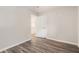 Bedroom with wood-look floors, white trim, a door to the hallway, and neutral paint at 1576 Thornwick Trce, Stockbridge, GA 30281