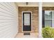 Close-up of the front door with brick accents and a welcoming entrance at 1576 Thornwick Trce, Stockbridge, GA 30281