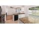 Open kitchen with granite countertops and bar seating overlooking the living area at 1576 Thornwick Trce, Stockbridge, GA 30281